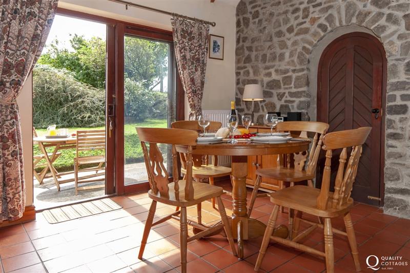 Dining area with patio doors to gardens at Torbant Fach, Trefin