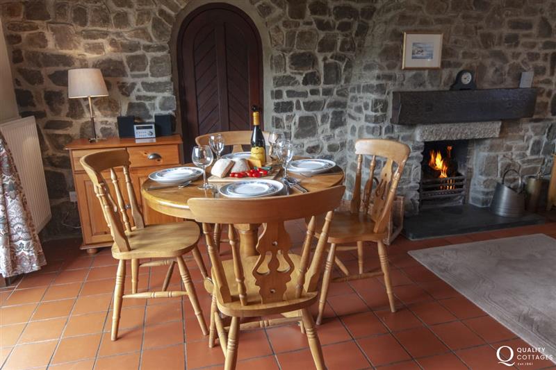 Open plan dining area with open fire at Torbant Fach, Trefin
