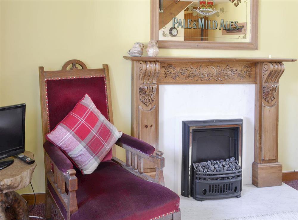 Feature fireplace within living and dining room at Kirkbrae, 