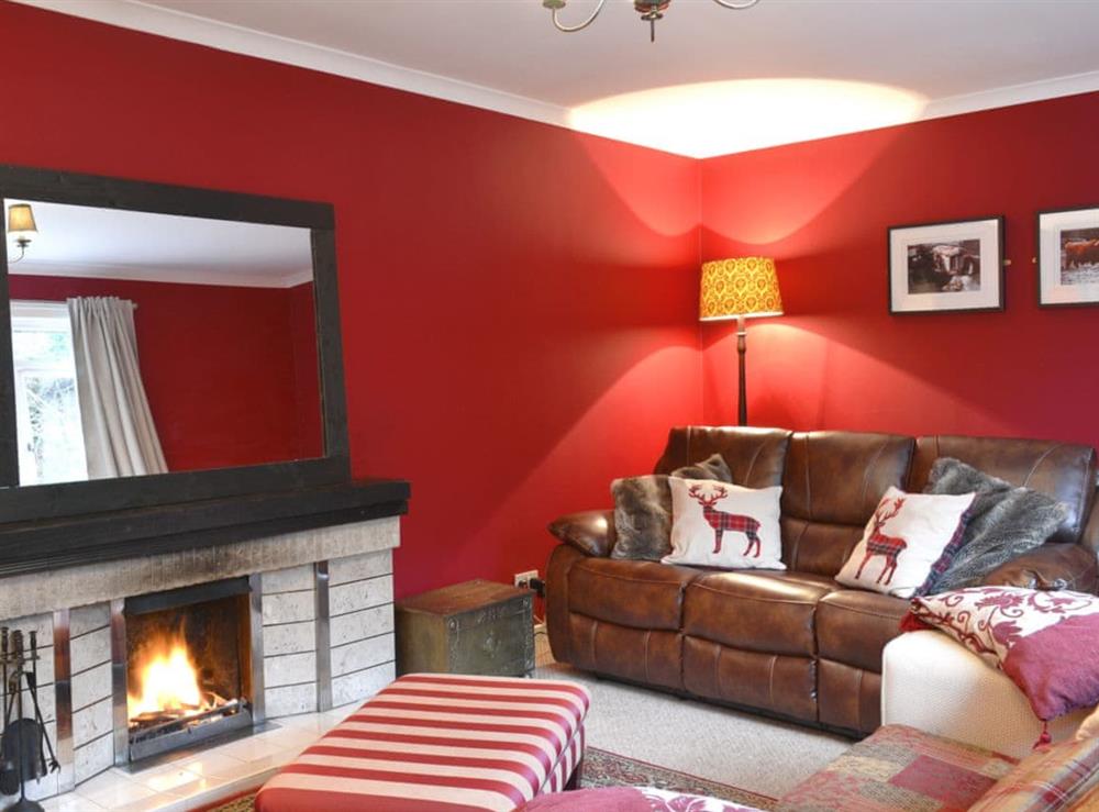 Cosy living room with an open fire at Torr Caladh in Glenfinnan, near Fort William, Inverness-Shire