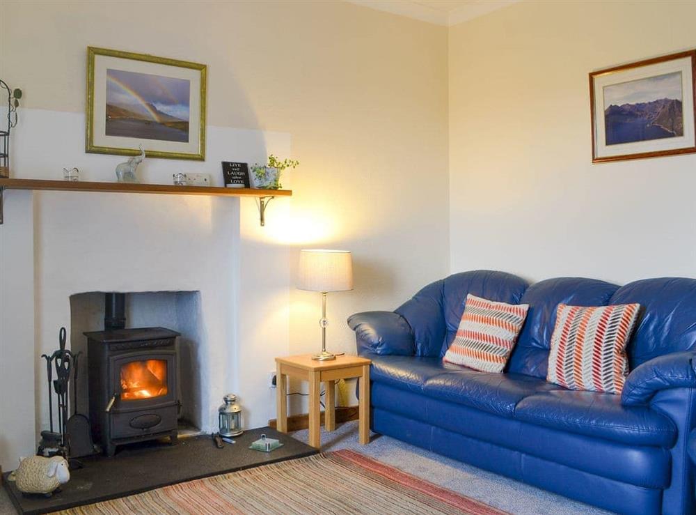 Comfy living room with a wood burner at Tote Cottage in Skeabost Bridge, Isle Of Skye