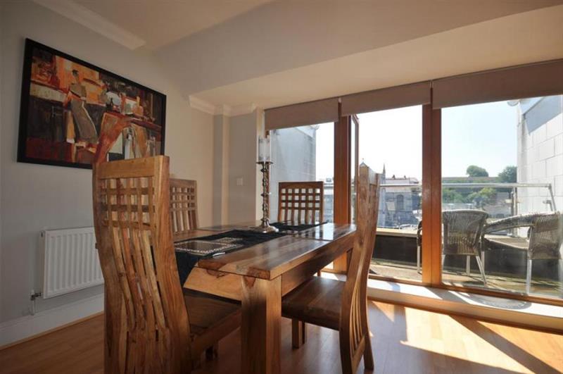 Dining area, with doors to the balcony at Townbridge Penthouse, Weymouth, Dorset