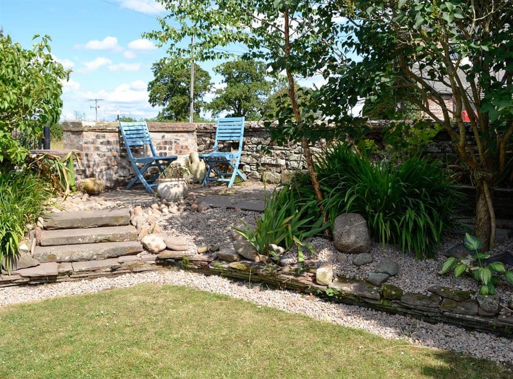 Garden with seating area at Townend Cottage in Wiggonby, near Carlisle, Cumbria