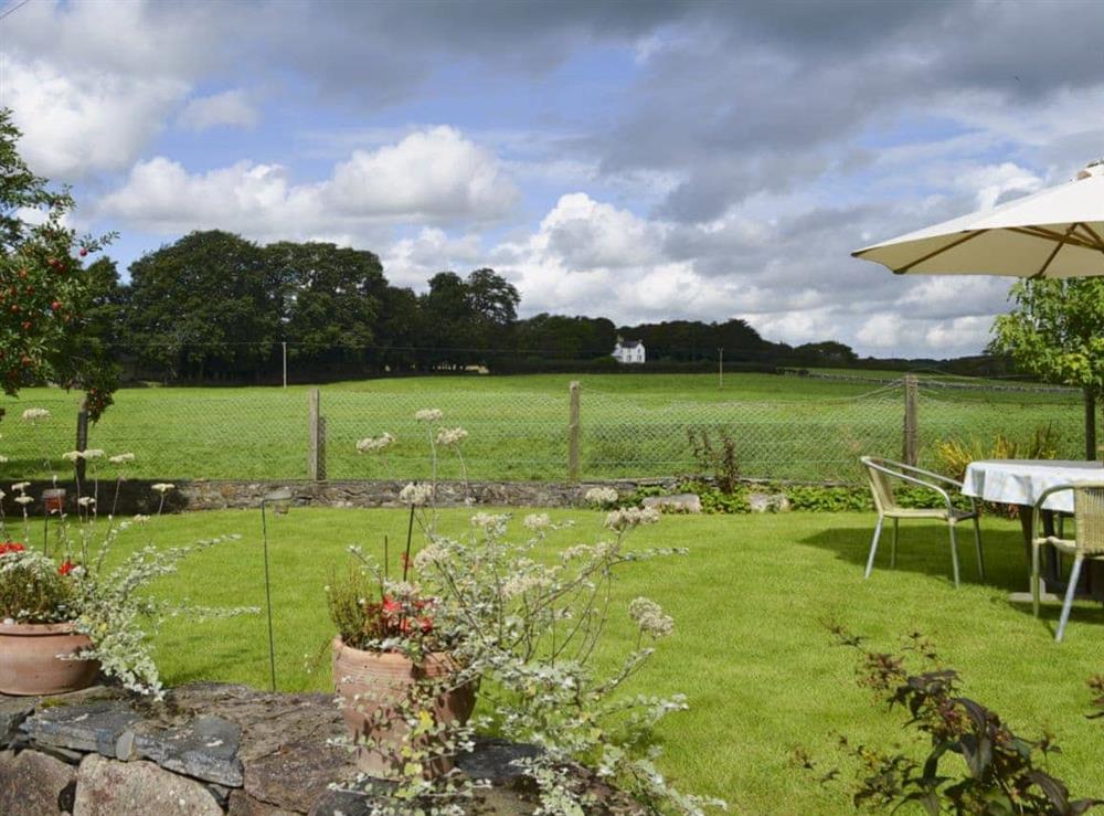 Enclosed garden boasting views over the countryside at Tre Anna Lodge in Dwyran, near Llanfairpwllgwyngyll, Anglesey, Gwynedd