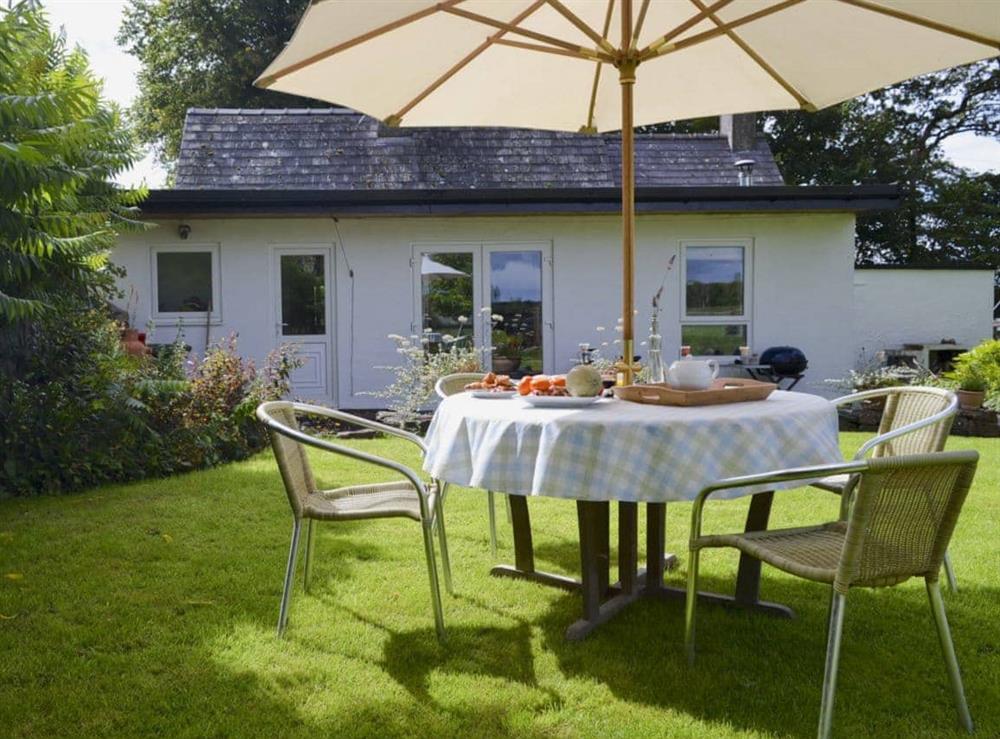Large enclosed lawned garden with patio, garden furniture and BBQ at Tre Anna Lodge in Dwyran, near Llanfairpwllgwyngyll, Anglesey, Gwynedd