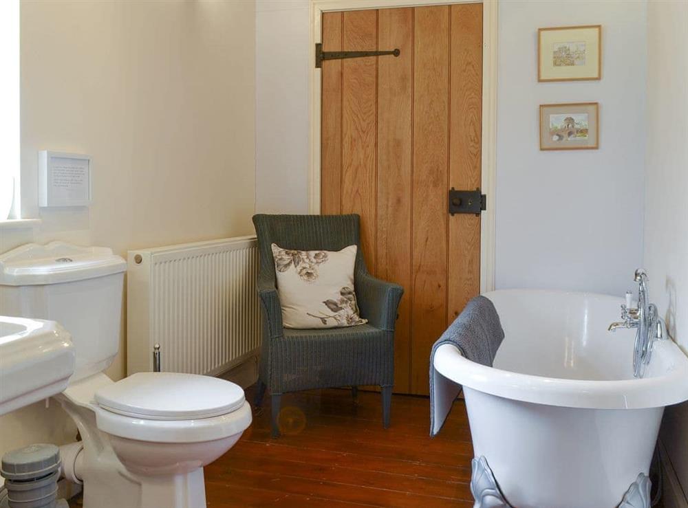 En-suite bathroom with bath and separate shower cubicle at The Cowshed, 