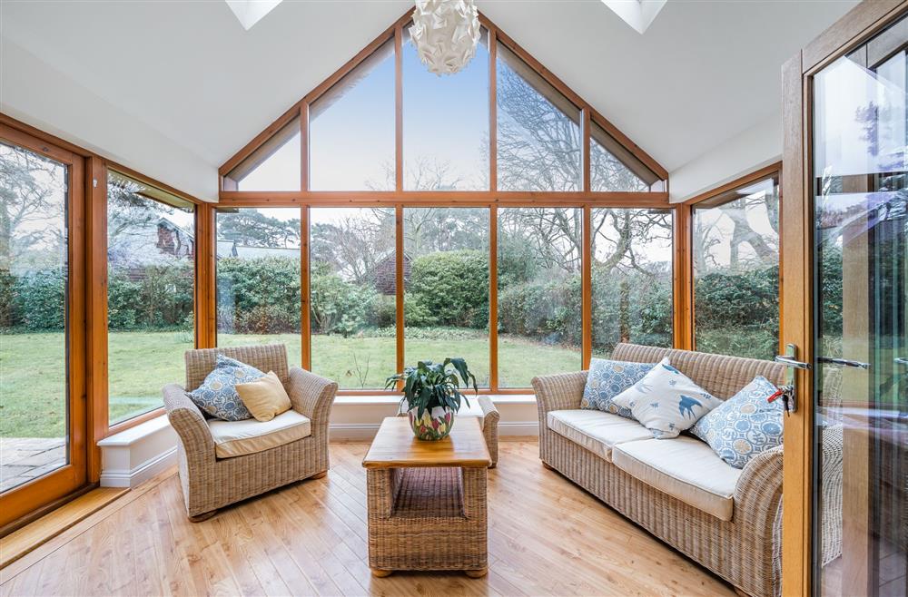 Glazed doors lead through to the sun room