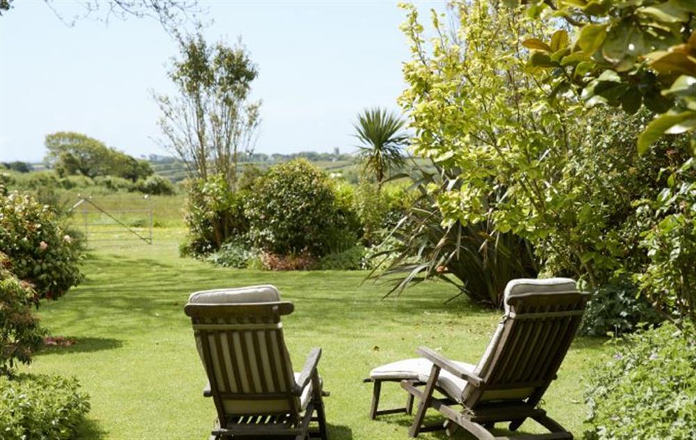 Enjoy the relaxing country views in the deck chairs from the lovely garden at Tregadjack Barn, Tregathenan