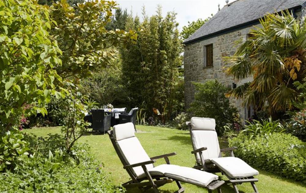 Relax in the outdoor furniture within the private garden at Tregadjack Barn, Tregathenan
