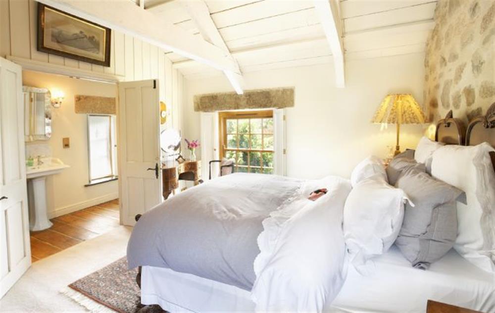 Double bedroom with 4’6 bed and en-suite shower room at Tregadjack Farmhouse, Tregathenan