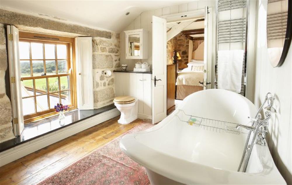 Family Jack and Jill bathroom with double ended slipper bath and WC (photo 2) at Tregadjack Farmhouse, Tregathenan