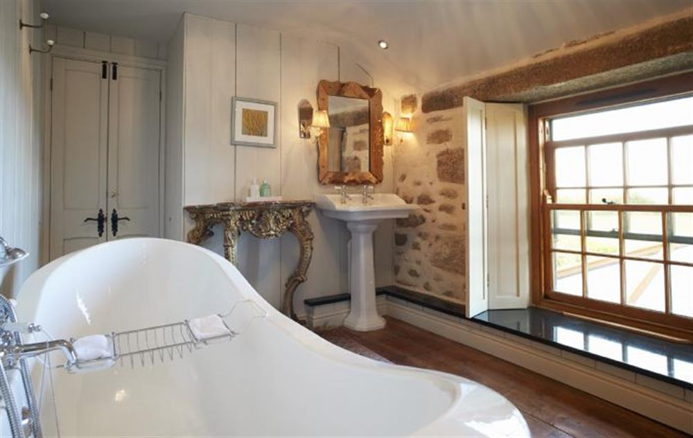 Family Jack and Jill bathroom with double ended slipper bath and WC (photo 3) at Tregadjack Farmhouse, Tregathenan