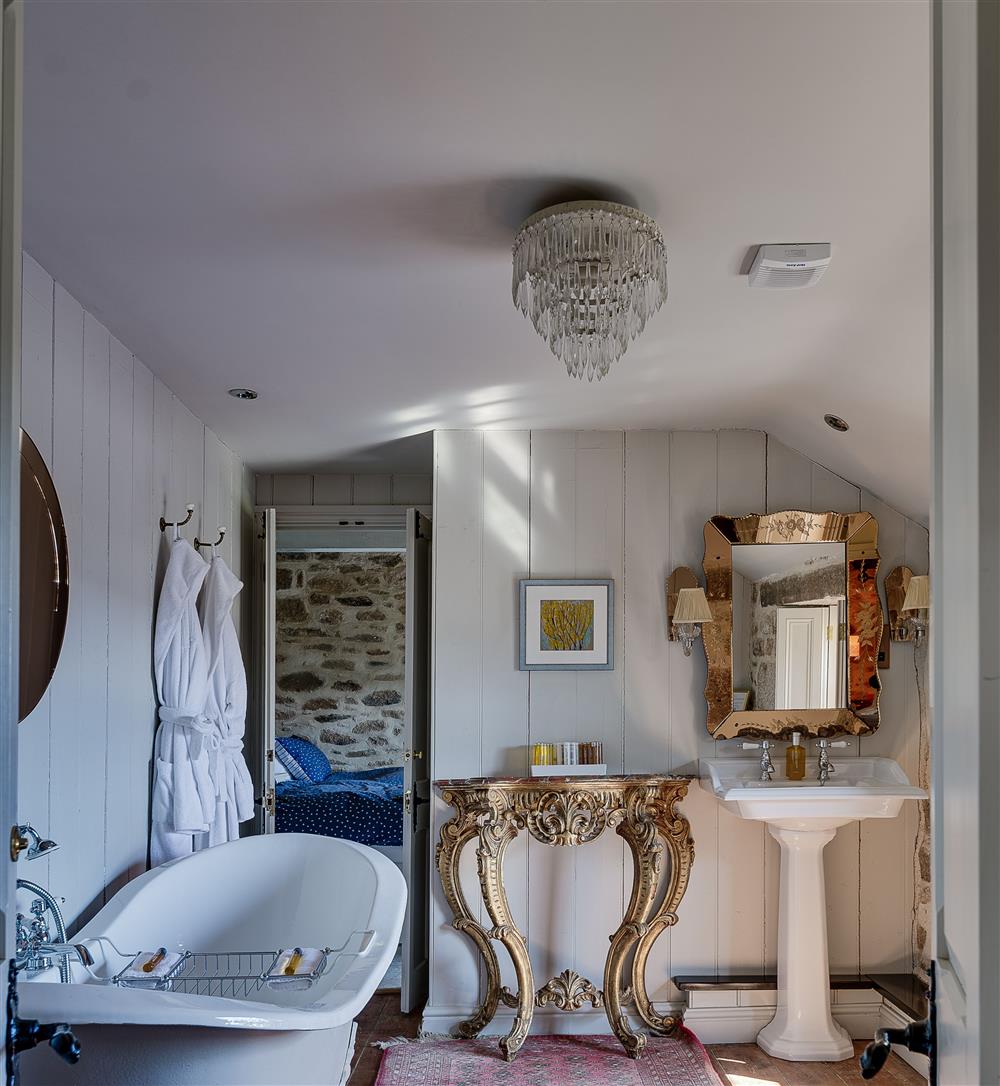 Family Jack and Jill bathroom with double ended slipper bath and WC at Tregadjack Farmhouse, Tregathenan