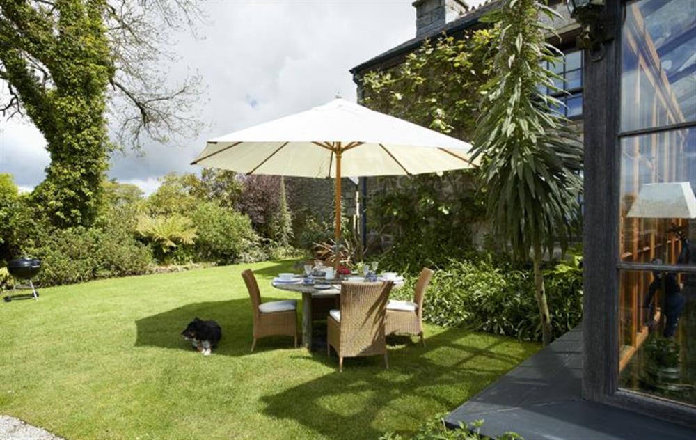 Sit outside in the stylish outdoor furniture and enjoy the relaxing gardens at Tregadjack Farmhouse, Tregathenan