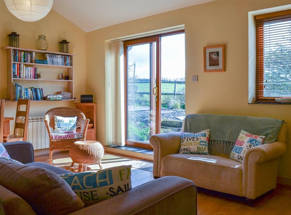 Beautiful living room with patio doors to the garden at Tregella Farm Cottage in Near Padstow, Cornwall
