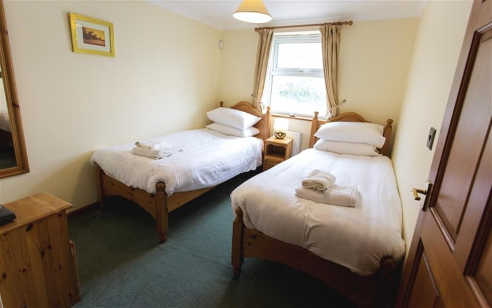 One of the bedrooms at Tregurrian Villa in Watergate Bay