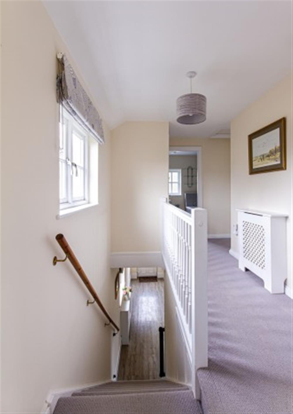 Landing area with stairs down at Trelawney Cottage in Wadebridge