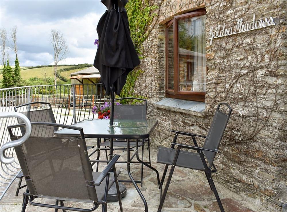 Enclosed courtyard with sitting-out area, garden furniture and BBQ at Golden Meadows, 