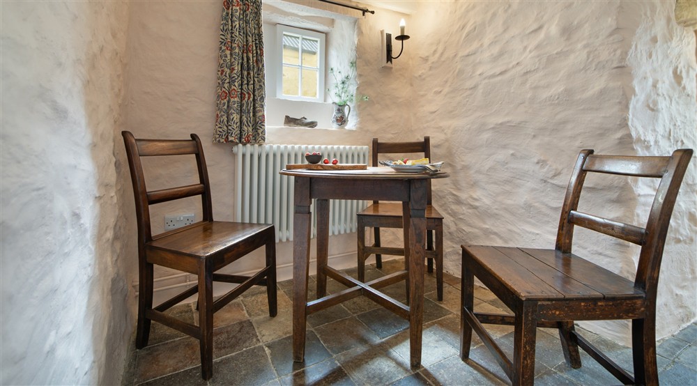 The table in the sitting and dining room at Treleddyd Fawr Cottage in Haverfordwest, Pembrokeshire