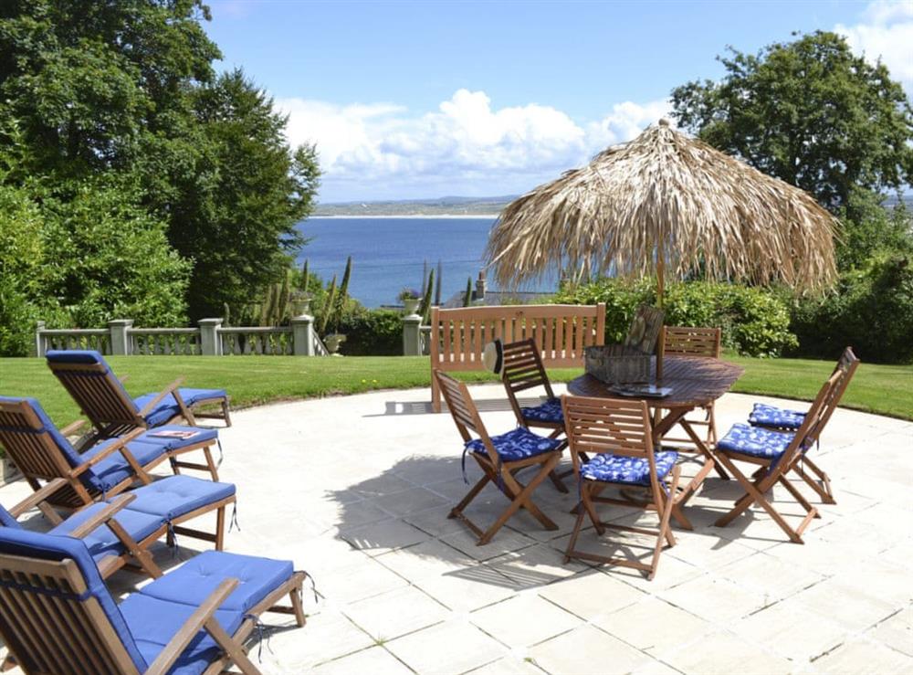 Stunning lawned and woodland grounds with patio and sun loungers at Rivendell, 