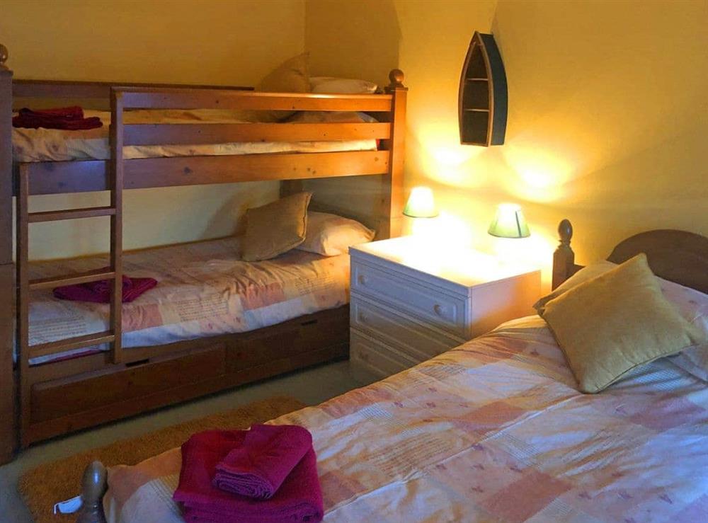 Bedroom boasting bunk beds and single bed at Tremaer in Bude, Cornwall., Great Britain