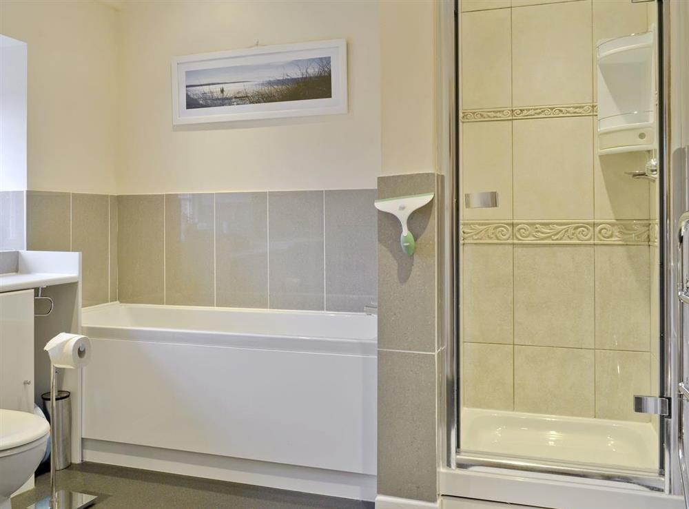 Modern bathroom with bath and separate shower cubicle at Trentham Cottage in Snettisham, near Hunstanton, Norfolk