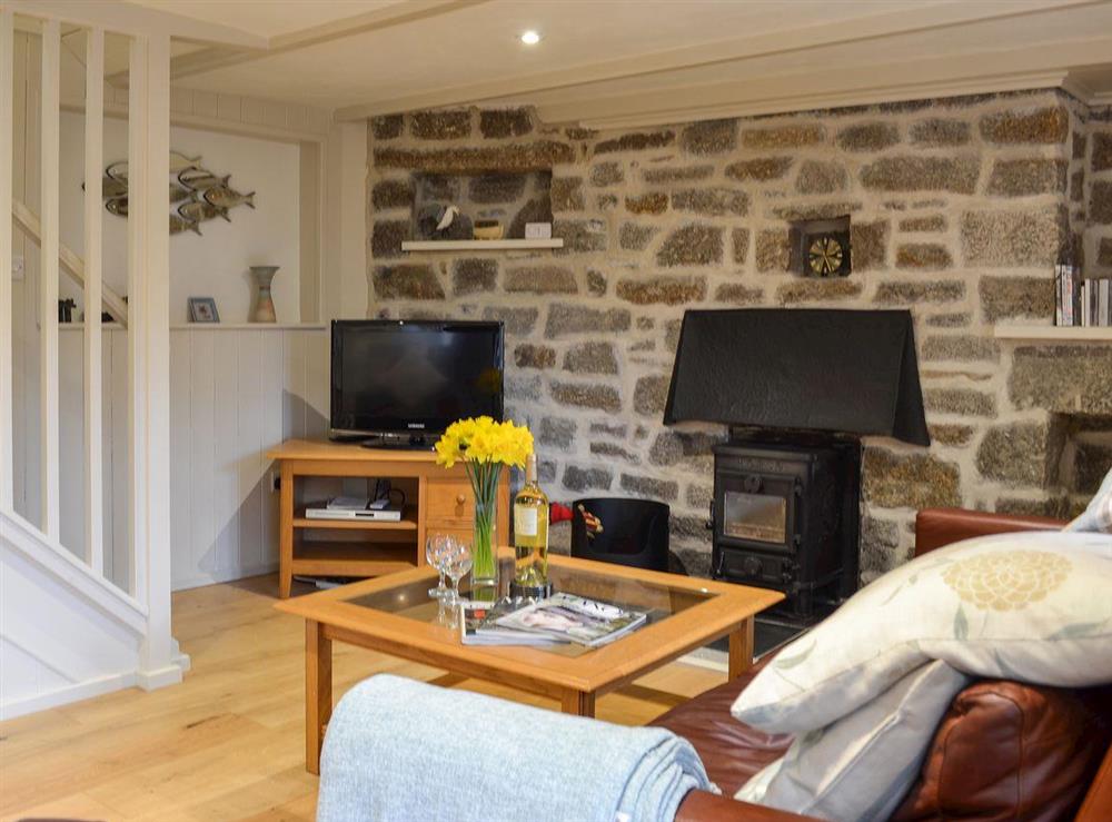Living room with wood burner & wooden flooring (photo 3) at Treveth Cottage in Lamorna, near Penzance, Cornwall, England