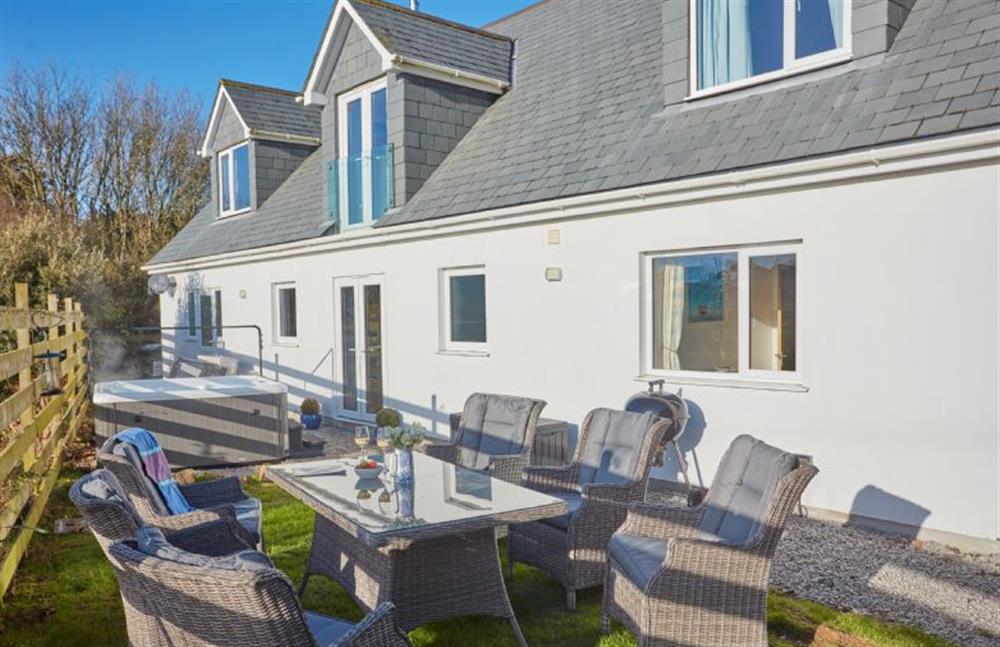 Treveth Lowen, Cornwall: The garden with ample garden furniture, barbecue and hot tub at Treveth Lowen, St Minver