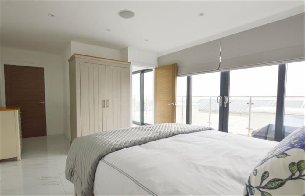 Bedroom three with king-size bed and patio doors (photo 2) at Trevose Penthouse, Newquay