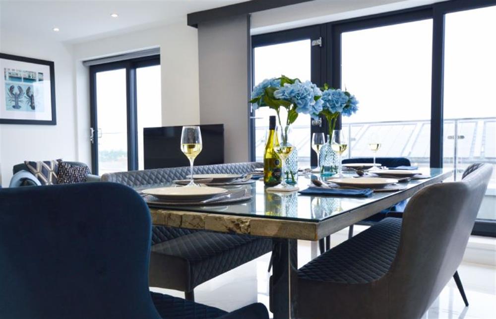 Dining area with table and seating for six at Trevose Penthouse, Newquay