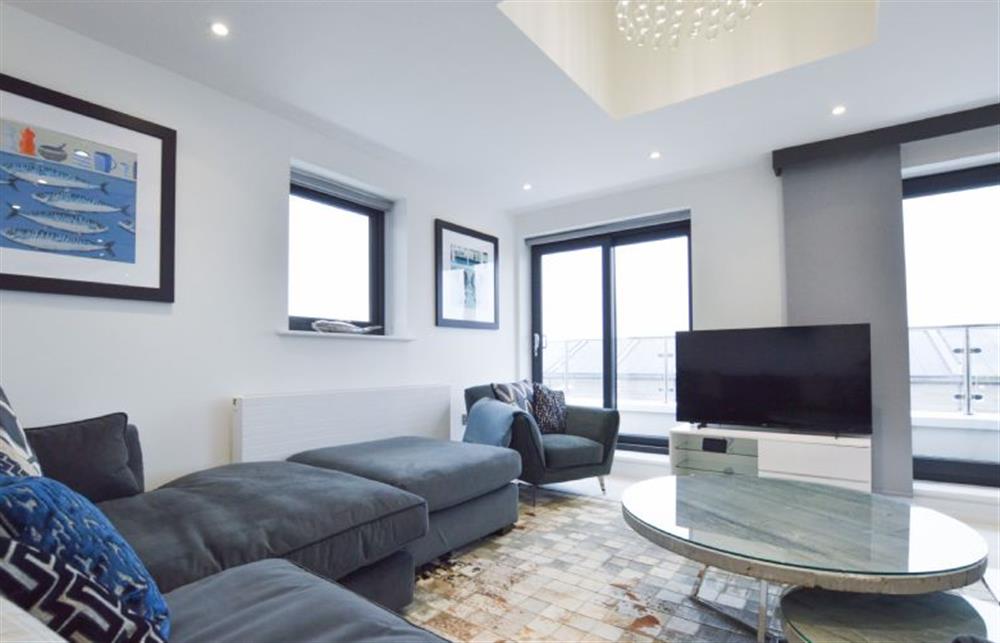 Sitting area with comfortable corner sofa, Smart television and views over Newquay (photo 3) at Trevose Penthouse, Newquay