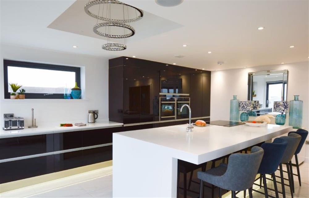 Well-equipped kitchen with dishwasher and washing machine at Trevose Penthouse, Newquay