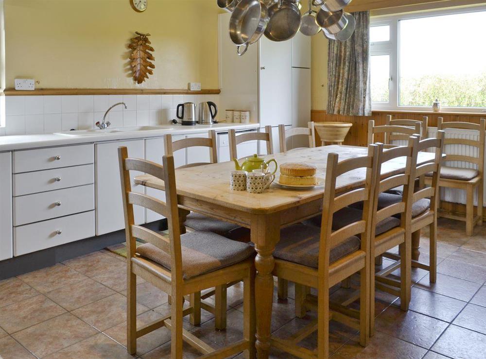Well-equipped kitchen with dining table at Trew House in Stratton, Bude., Cornwall