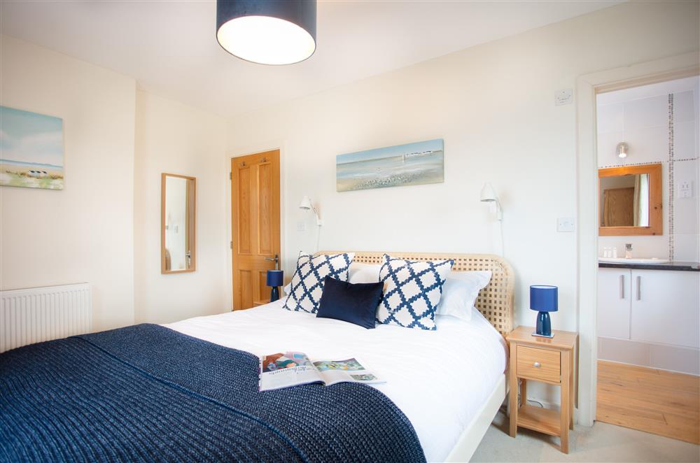 King-size bedroom with balcony and en-suite shower room at Trewalder, Treyarnon Bay, St Merryn