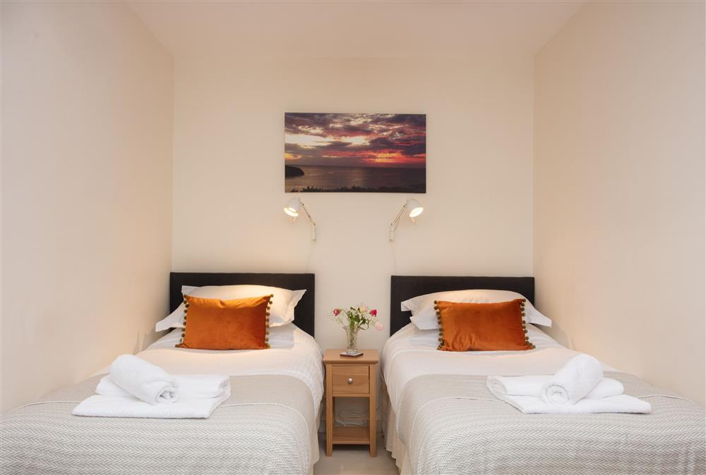 Twin bedroom with two single beds with balcony with views of Treyarnon Bay at Trewalder, Treyarnon Bay, St Merryn