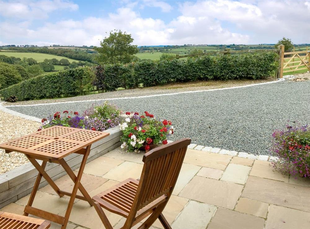 Sitting out area with countryside views at Trezeal View in North Hill, Cornwall