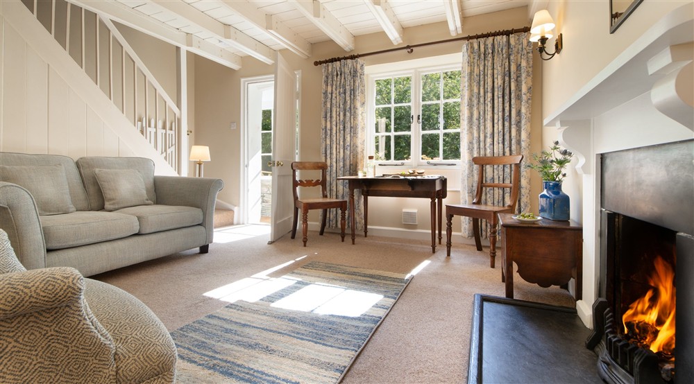 The sitting room with table for two at Triggabrowne Cottage in Lanteglos-by-fowey, Cornwall
