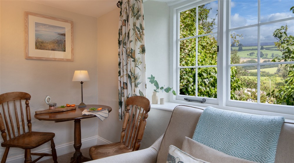 The sitting and dining room (photo 2) at Triggabrowne Dairy Cottage in Lanteglos-by-fowey, Cornwall