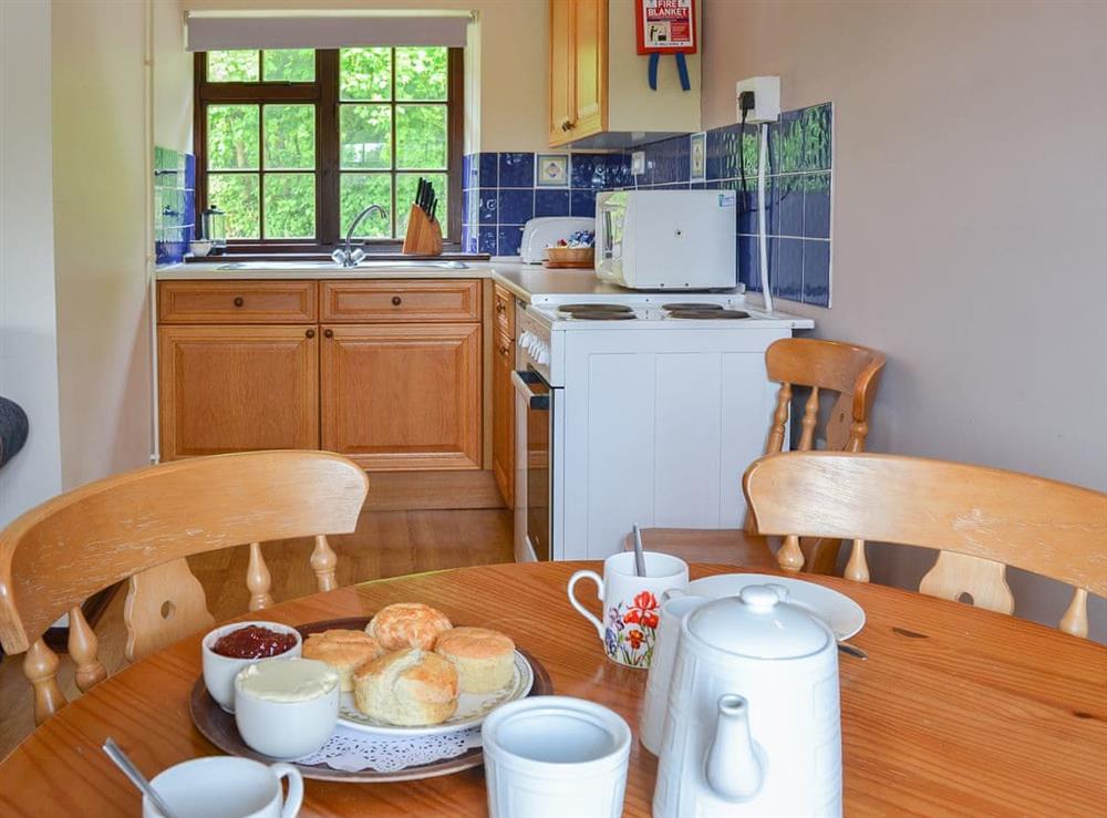 Modest dining area and adjacent kitchen at Gate Cottage, 