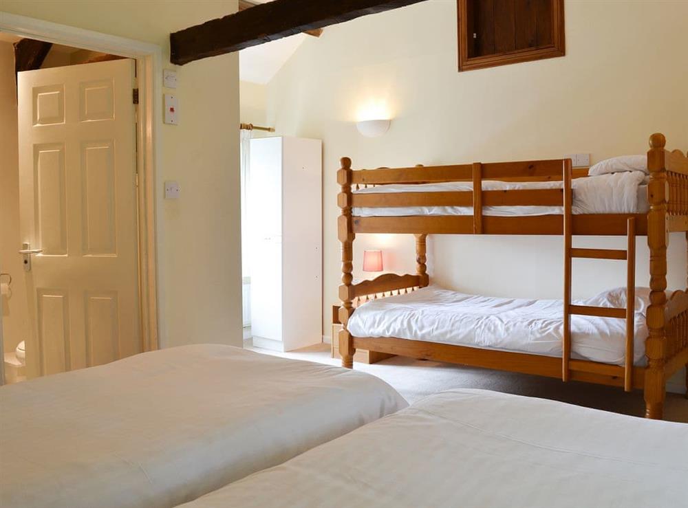 Bedroom with twin beds and children’s bunk beds (photo 2) at Granary, 