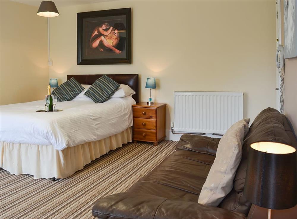 Delightful open plan living area with comfortable double bed at Lee Studio, 