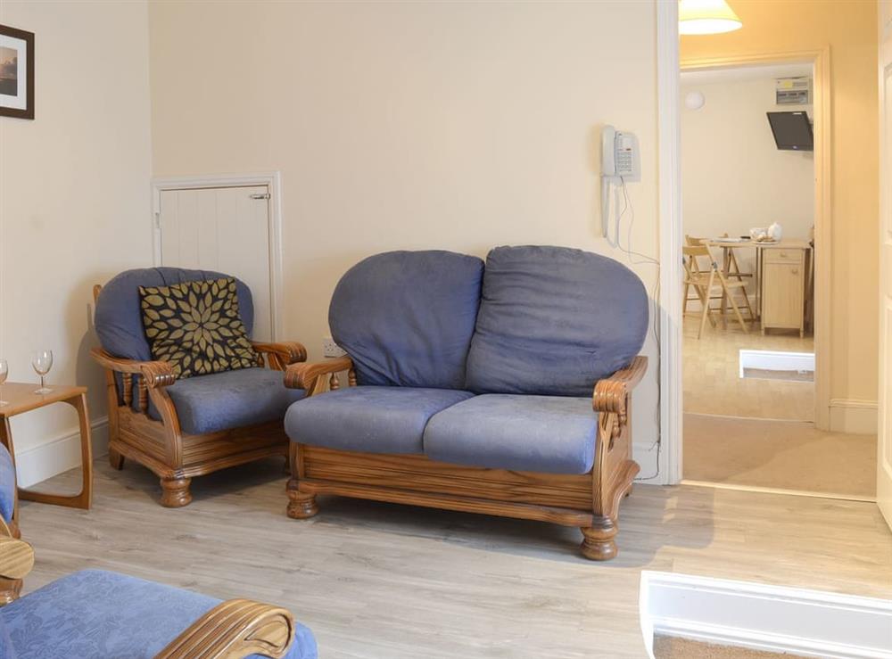 Comfy seating within sitting room at Paddock Cottage, 