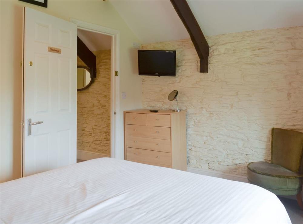 Exposed wood beams in double bedroom at Paddock Cottage, 