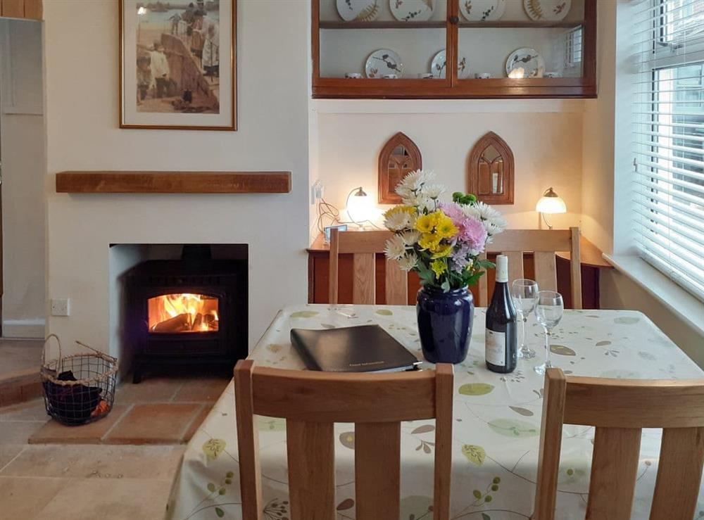 Dining room with wood burner at Trinity Cottage in Wells-next-the-Sea, Norfolk