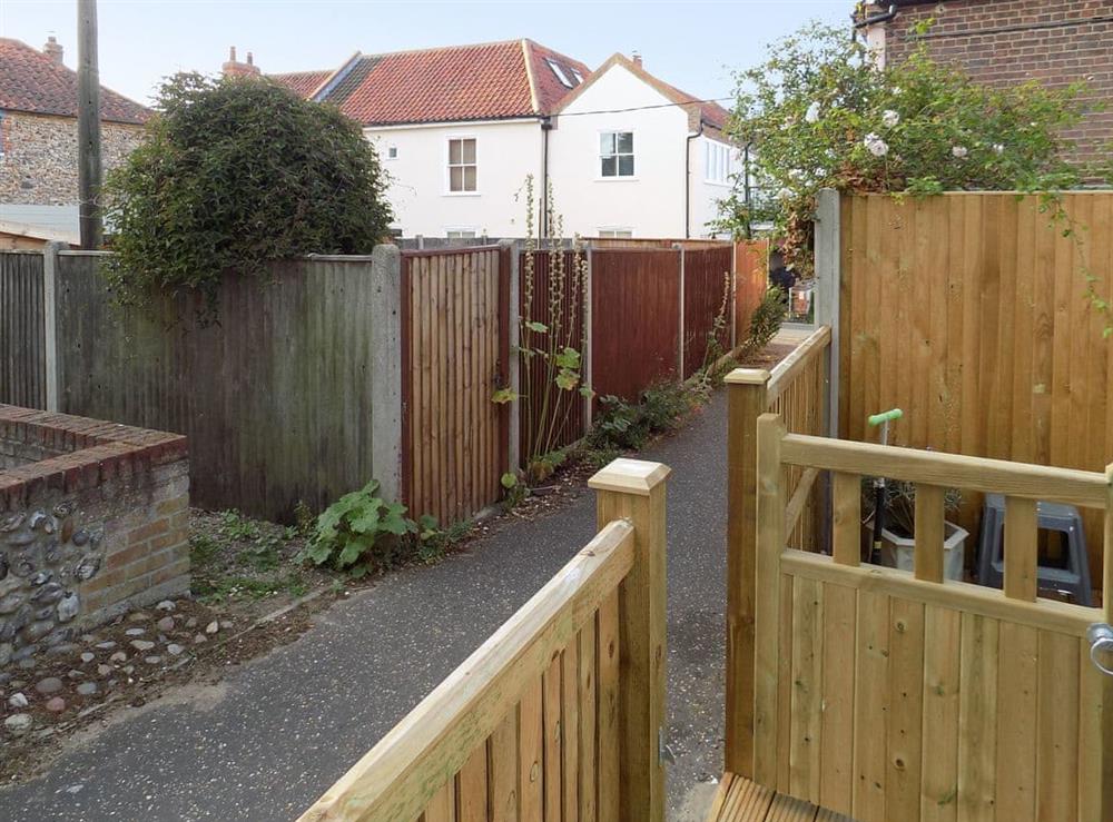 Patio opens up to a path to the harbour at Trinity Cottage in Wells-next-the-Sea, Norfolk