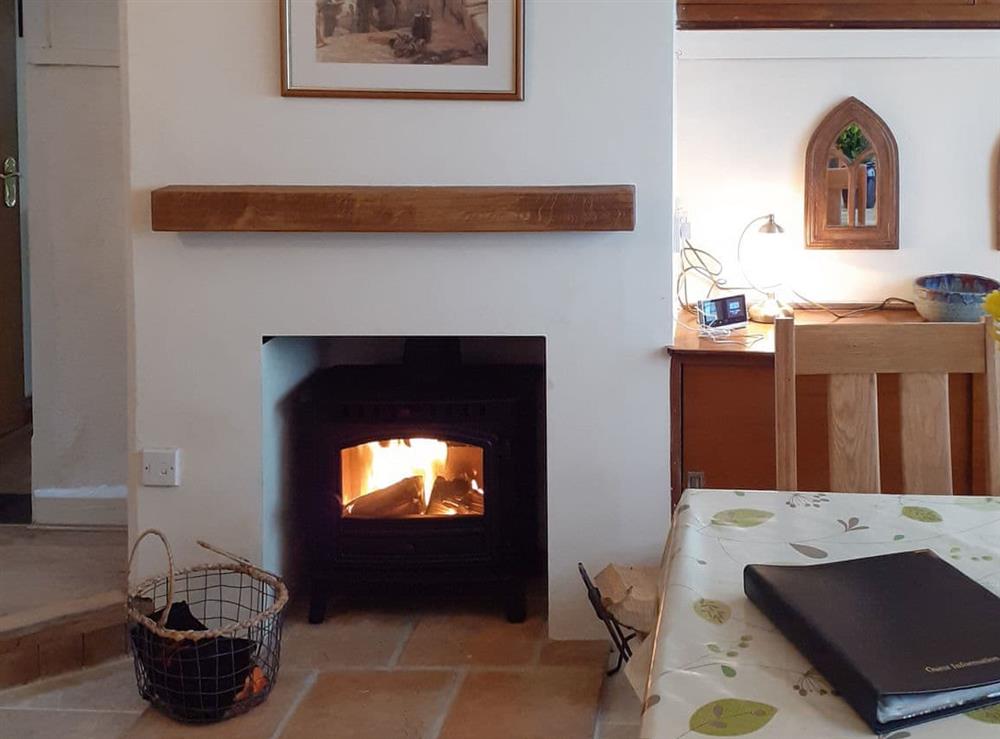 Warming wood burner within the dining room at Trinity Cottage in Wells-next-the-Sea, Norfolk