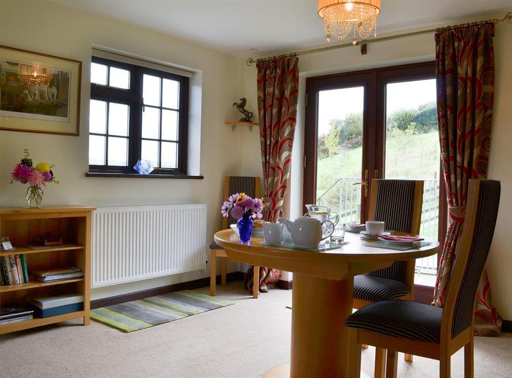 Dining area and access to the garden at Tripp Cottage in St Neot, near Liskeard, Cornwall