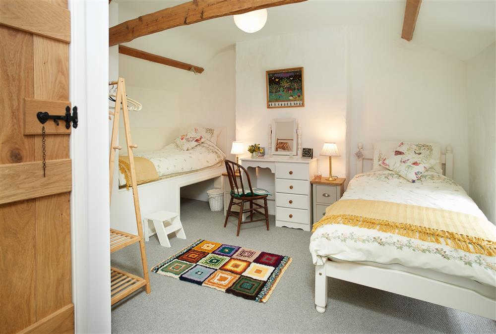 Bedroom two with twin 3’ single beds and exposed beams at Troedrhiwfawr, Aberystwyth