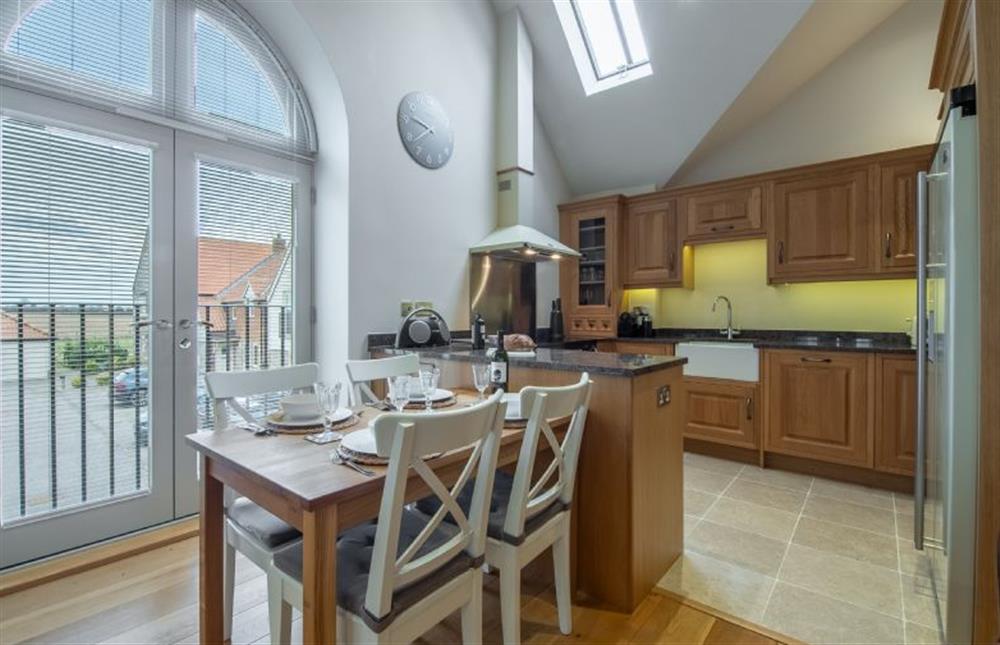 First floor: Dining area with kitchen at Tucked Away Cottage, Langham  near Holt