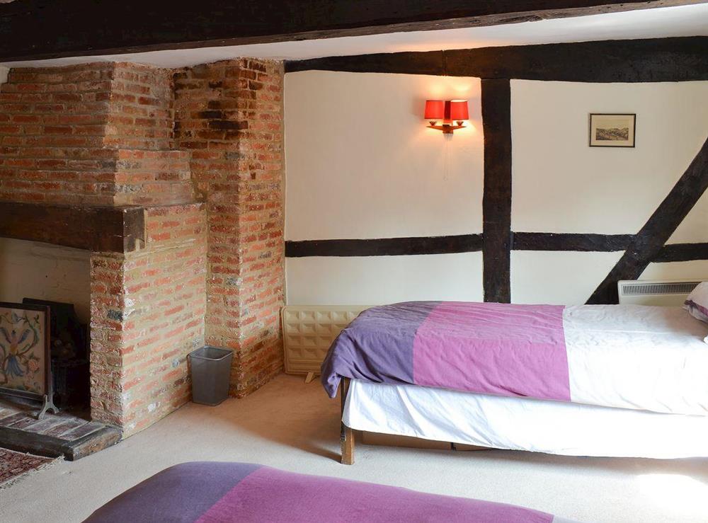 Bedroom with double and additional single bed at Tudor Cottage in Romsey, Hampshire